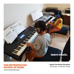 Learning is often more fun together. In our Gurugram studio, two young students are engaged in a keyboard lesson, using headphones to focus on their individual practice while learning side by side.