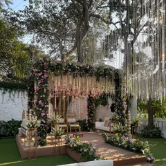 This traditional mandap is a vision in pastel pinks and whites. We used hanging floral arrangements and classic seating to create a space that feels both grand and intimately romantic.