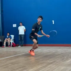 Zehn Masani perfecting his form during a practice session. The focus here is on explosive movement and precise shuttle control, key elements for an attacking player.