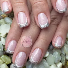 The silver lining. This manicure screams sophistication with its shimmery pink base and sparkling silver French tips.