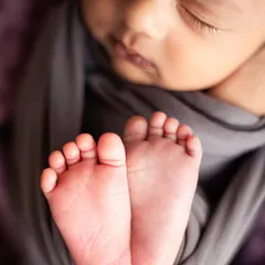 A close up of tiny, perfect toes. I believe every detail is part of your baby's story, and I make sure to capture these small features that you'll want to remember forever. This is a classic shot in my newborn photography sessions.