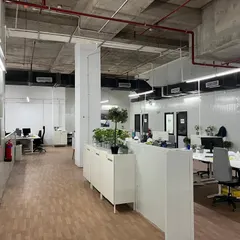 Another perspective of the open-plan office, highlighting the clean wall paneling and organized desk arrangements. This demonstrates our attention to creating an orderly and efficient work environment.
