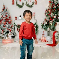 A happy boy standing proudly amidst the Christmas decorations. Solo portraits during a family session are a wonderful way to capture each child's individual personality.