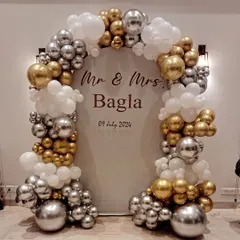 Congratulations to Mr. & Mrs. Bagla on their anniversary. We created this elegant personalized backdrop with a chrome gold and silver balloon arch to help them celebrate their special day in style.