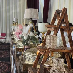 We use a mix of textures and elements like wood, crystal, and florals to create a visually rich buffet landscape. This setup for a wedding reception highlights our attention to decorative detail.