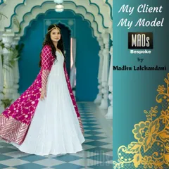 For clients seeking a fusion look, I create Indo-Western gowns like this one. It combines the grace of a flowing white anarkali with a richly decorated pink jacket, making it ideal for a cocktail party or wedding reception.