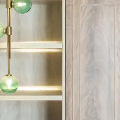 The green pendant light seen next to the light wood of the open shelving. This juxtaposition of color, material, and light is a hallmark of our detailed approach to design.