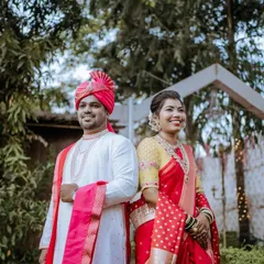 A classic portrait of the couple in their wedding attire. Their happy, relaxed expressions are captured against a lovely outdoor backdrop, making for a perfect memory.