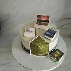 For a software programmer. This cake features a laptop, coding language, computer engineering books, and a cutaway showing a circuit board inside.