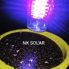 A view of the Solar Insect Trap operating at night. The purple UV light effectively draws in flying pests, which are then collected in the basin below, demonstrating its efficiency in real time.
