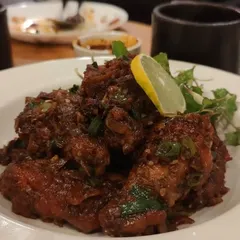 A close-up of our spicy chicken, tossed in a rich sauce with fresh herbs and a squeeze of lemon. This dish is perfect for those who enjoy bold and fiery flavors.