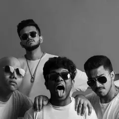 A stylized black and white group portrait of the band. This image has a completely different mood, showcasing a cooler, more serious, and fashion-forward side to their persona.