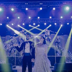 The couple takes center stage for their Sangeet performance, backed by professional dancers and dramatic lighting.