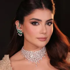 This is couture glamour for a cocktail or reception event. The look features bronzed, glowing skin and a dramatic smoky eye, paired with a nude lip to create a perfect balance of sophistication and allure.