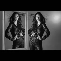 An edgy, conceptual fashion shot in black and white featuring a leather ensemble. I used a mirror and dynamic hair movement to create a sense of duality and energy, perfect for a bold editorial story.