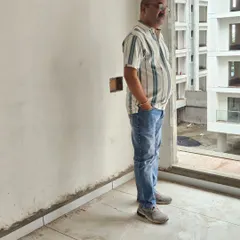 Taking a moment to assess the view and energy from a large window in a high-rise apartment. The external environment significantly influences the internal Vastu.
