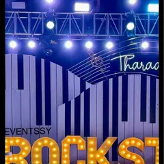 A close-up of the "ROCKSTAR" marquee letters on the main stage. The bright lights and bold lettering are essential elements for creating an authentic concert feel for this music-themed birthday.