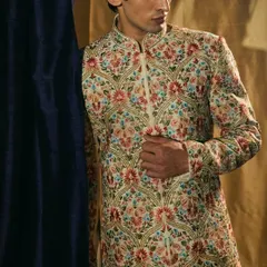 A closer look at the dense, vibrant Resham embroidery that covers our signature groom's sherwani, a testament to the skill of our master artisans.