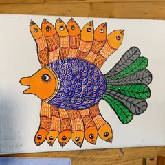 A student's fantastic Gond fish painting on canvas. The intricate patterns and lively colors showcase the imaginative spirit of this art form, which we help our students to channel.