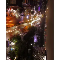 A long exposure style aerial photo showing light trails from traffic on a busy city street at night. This is a creative technique I use to add an artistic touch to my shots.