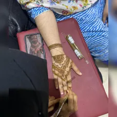 Here you can see a student practicing a mandala-style pattern on the back of the hand. My classes are hands-on, ensuring you get practical experience with every technique.