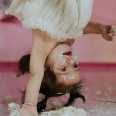 This is what happens when you give a one year old her own cake. This upside-down moment was a hilarious surprise during our session, a perfect memory of her playful spirit.