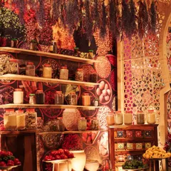 To create an authentic Moroccan spice market, we designed a backdrop with a vibrant spice print and built shelves filled with jars of real spices and hanging dried herbs. The sights and smells made the experience truly immersive.