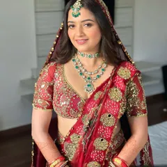 A closer look at this soft glam on a traditional red outfit. Her natural glow shines through the base, with feather-light lashes and a delicate nude lip to balance the richness of her attire.