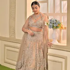 A full-length view of the minimalist sangeet outfit. The makeup is kept soft and elegant to complement the heavily embellished lehenga, creating a balanced and sophisticated look.