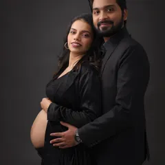 A classic and elegant black-and-white themed maternity shoot. The makeup is sophisticated and timeless, creating a powerful and intimate portrait.