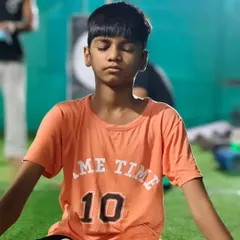 Learning the importance of a calm mind. This young member practices seated meditation with the group.