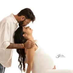 A simple yet powerful pose showing the connection between the couple. The partner leans in from behind, creating a feeling of support and love in this clean, high-key shot.