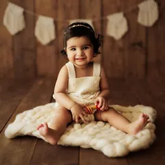 A full view of the setup, with the baby sitting confidently and smiling. These sessions are all about capturing their newfound independence.