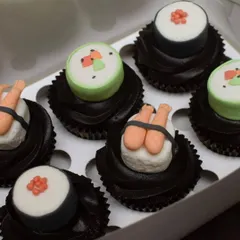 A close-up of the handcrafted fondant sushi toppers. I used different colours and shapes to create realistic-looking maki rolls and shrimp nigiri, placed on dark chocolate frosting to make the details pop.