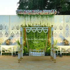 A wide shot of the naming ceremony setup, showing the balance of traditional and modern elements. The stage is illuminated with soft spotlights to create a warm and inviting atmosphere for the family.