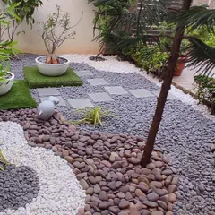 Another view of the pebble garden, showing the pathway made of stone pavers set amidst the pebbles. This design is perfect for clients who want a unique, artistic garden without the constant upkeep.