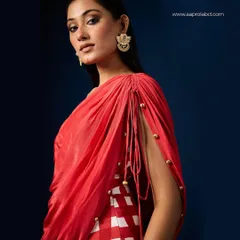 The dramatic draping of this Aapro dress is highlighted by precise side lighting, showcasing the texture and flow of the fabric.