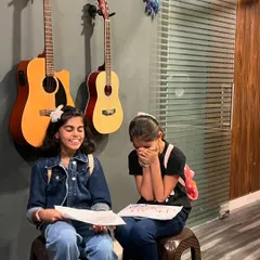 A moment of pure joy and friendship during a kids' music session. We focus on creating a comfortable space where children feel free to express themselves and have fun.