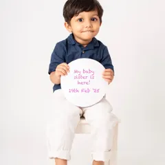 Getting ready for big brother duties! Including older siblings in the announcement is a wonderful way to make them feel part of the journey. This little boy looks so proud to share the news about his baby sister.