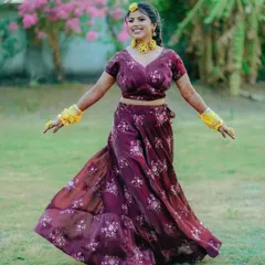 A happy bride twirls in her beautiful floral lehenga during her outdoor Haldi celebration. This shot is full of life and movement.