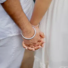 A close-up of the couple holding hands, a simple yet powerful detail shot from their pre-wedding session.