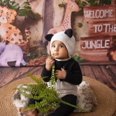 This little panda is exploring the jungle. Themed sessions like this are so much fun for sitter-age babies.