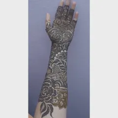 The same intricate bridal arm design, shown from a slightly different angle. The fine line work and shaded details are clearly visible in this shot.