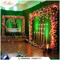 A beautiful floral photo booth with a hanging swing. The area is framed by a square floral arch and a backdrop of hanging crystals and candles, creating a romantic and whimsical spot.