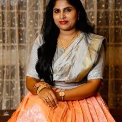 A relaxed portrait of a wedding guest, beautifully lit against a warm indoor background. I make sure to capture the friends and family who share in your joy.
