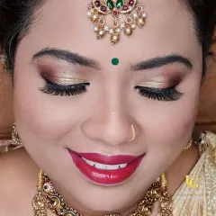 A close-up of a classic bridal look. We'll go in-depth on how to apply glitter eyeshadow for that pop, define the brows, and choose the perfect bold lip color to complete the traditional attire.