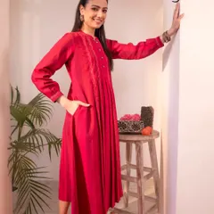 This Haveli dress in a vibrant red features intricate Chikankari embroidery. Crafted from breathable handwoven cotton, it's perfect for making a statement at your festive celebrations.