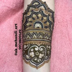 The same arm band design after the henna paste has been applied to the negative spaces, showing the complete look.