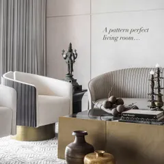 A pattern-perfect living room that is a study in restrained elegance. We believe in layering textures, clean forms, and quiet luxury to create a space that feels both timeless and lived-in. Here, a pleated sofa, a brass-finished coffee table, and an ancestral bronze statue come together in quiet harmony.