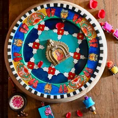 This is my hand-painted homage to Laxmi, the goddess of prosperity, set within a reclaimed clock frame. The artwork is filled with symbols like owls and lotuses, all rendered in the Pattachitra style and surrounded by colorful, found-object trims.
